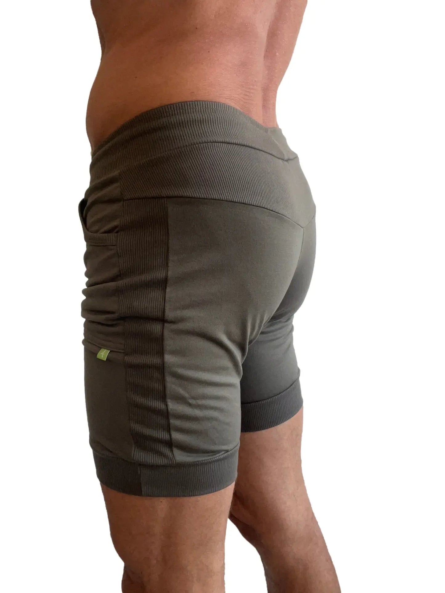 Olive green cuffed yoga shorts with ribbed side panels and elastic waistband for comfortable athletic wear