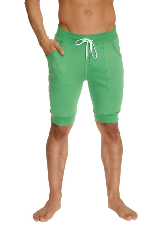 Green cuffed yoga shorts made from bamboo fabric featuring a white drawstring and side pockets