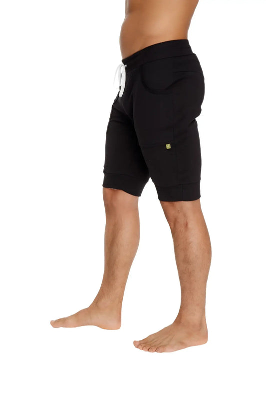 Black cuffed yoga shorts with white drawstring and small green logo ideal for comfortable activewear