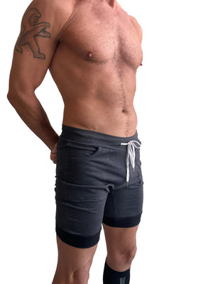 Cuffed yoga short in charcoal with black cuff featuring dark gray athletic fabric and white drawstring detail