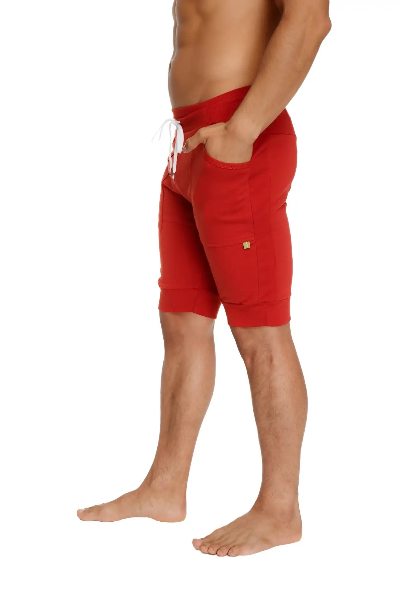 Cuffed yoga shorts in cinnabar red with white drawstring and side pockets for comfortable athletic wear