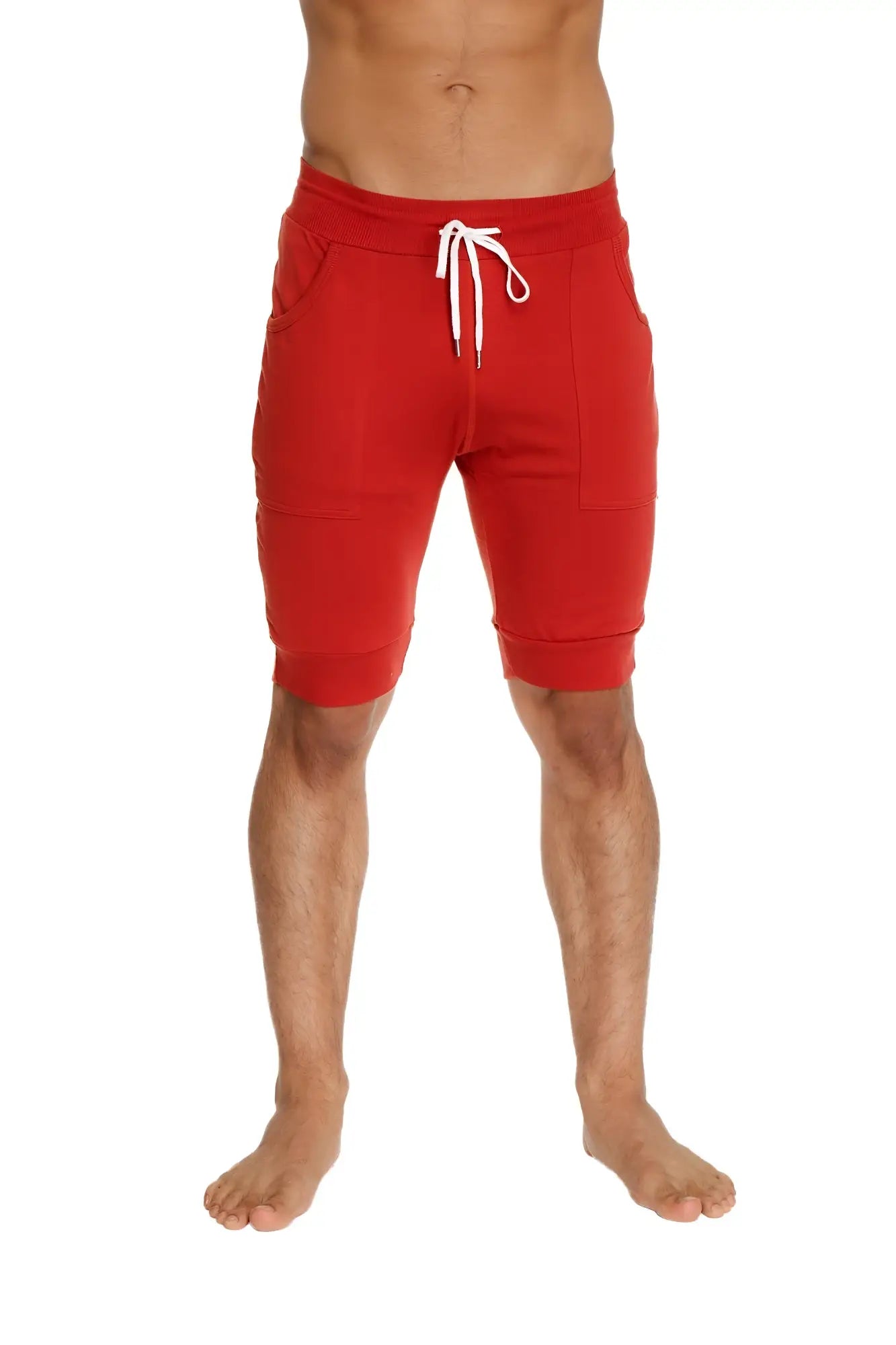 Red cuffed yoga shorts with white drawstring and side pockets designed for athletic use in cinnabar red color