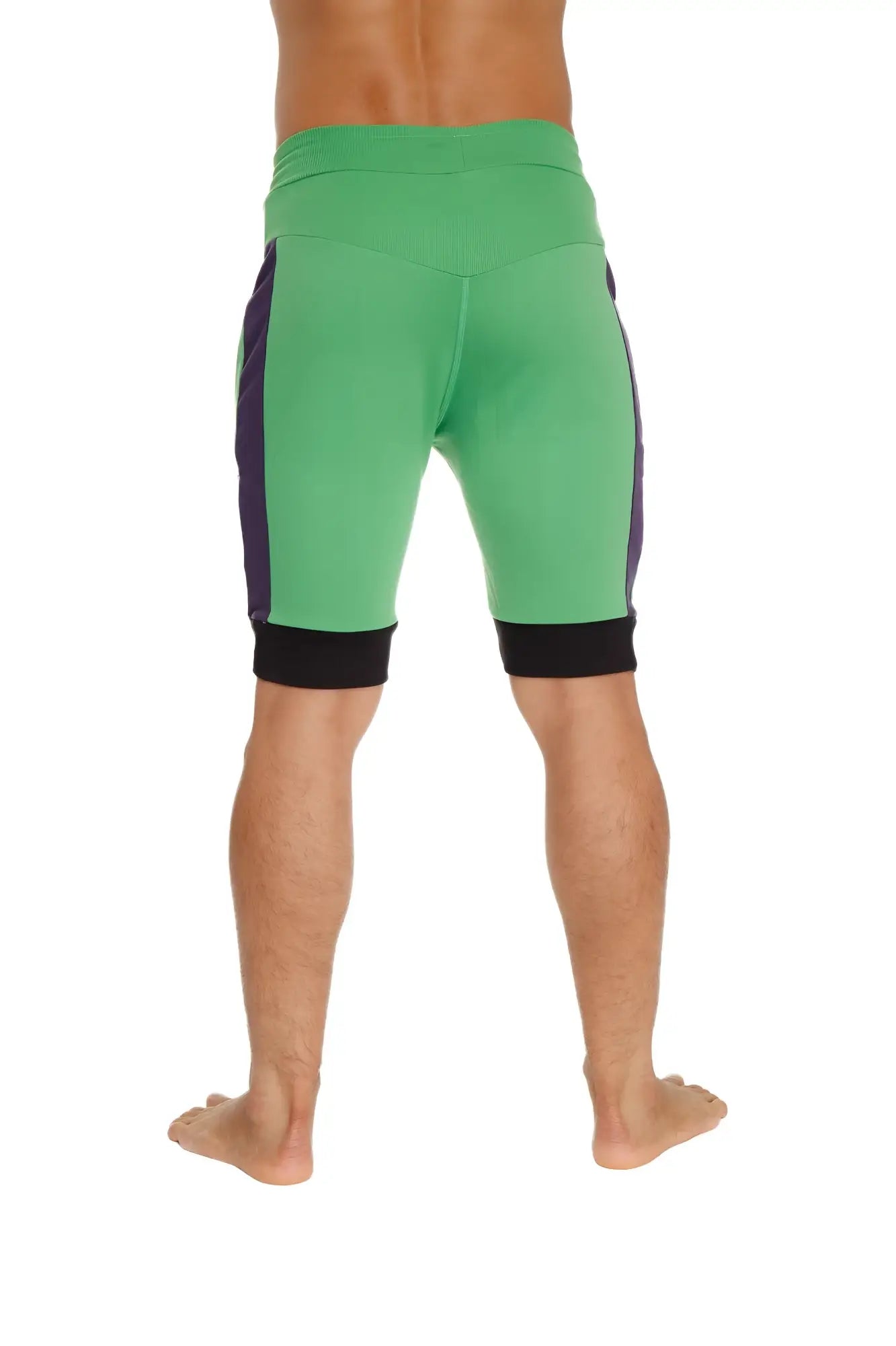 Green cuffed yoga shorts with purple side panels and black trim at waistband and cuffs for athletic wear