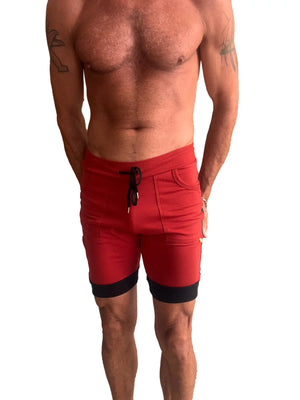 Red cuffed yoga shorts with charcoal and black trim featuring a drawstring waistband for athletic use