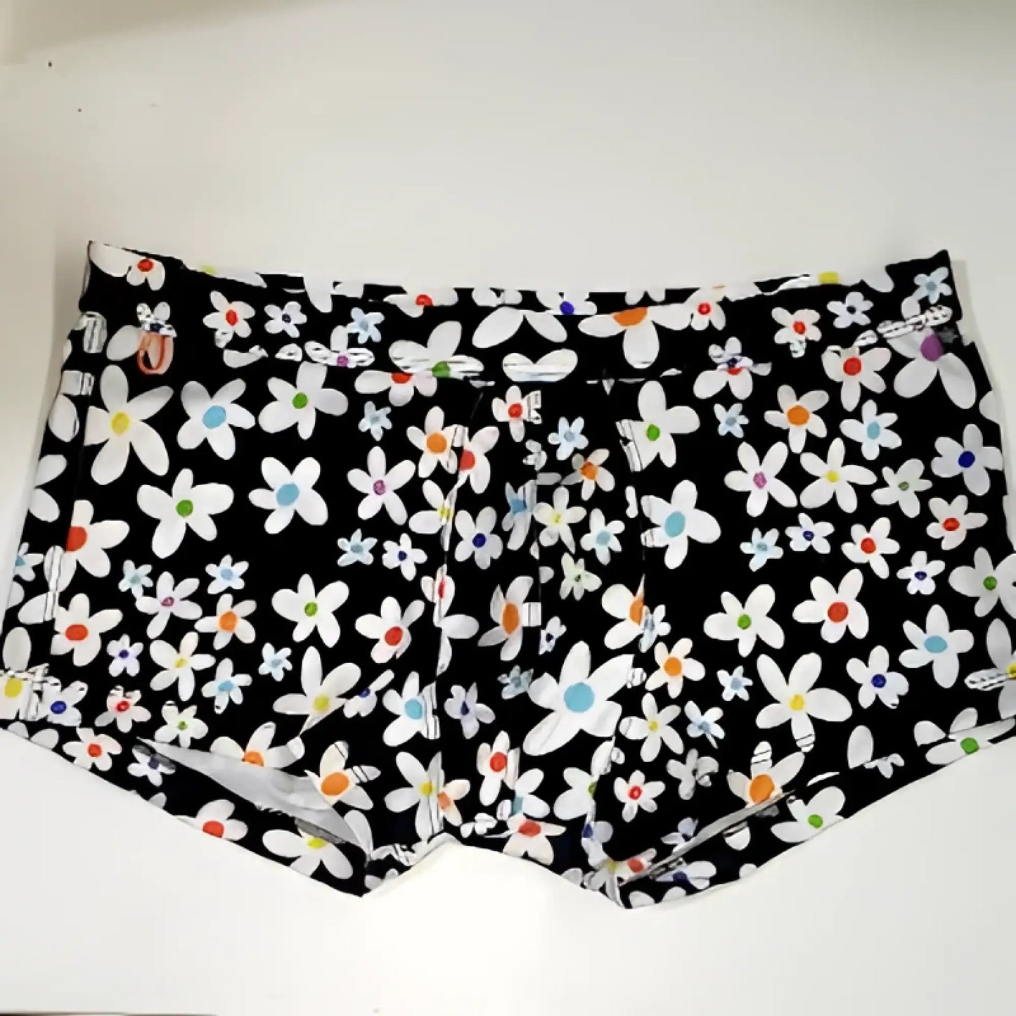 Black briefs daisy sq cut with vibrant white daisies featuring blue orange and red centers on front side