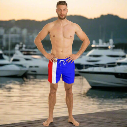 Men's swim shorts in blue with red and white stripes featuring a drawstring waist shown by a model by Maris Equi.