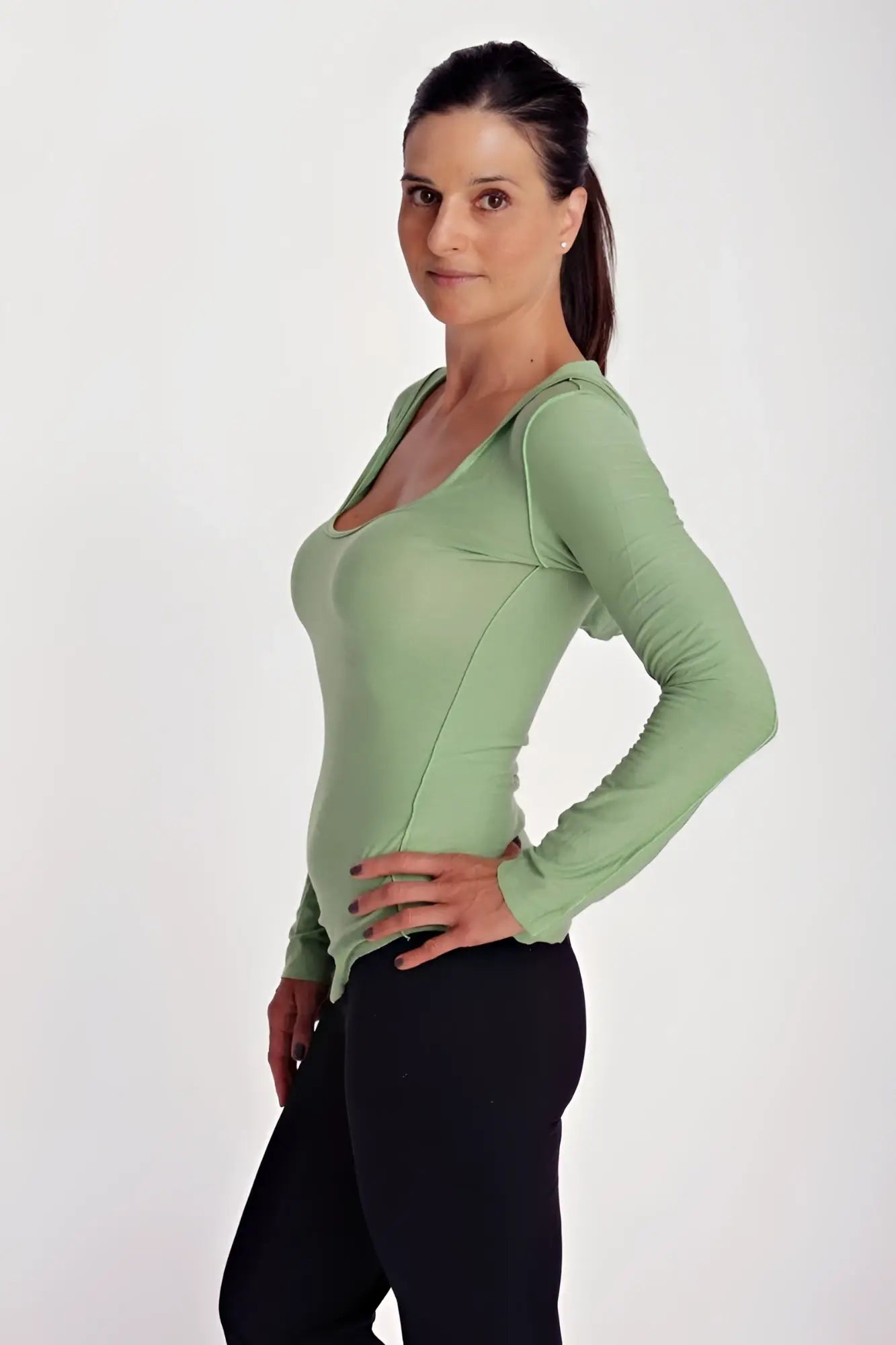 Deep scoop neck long sleeve hoodie top in bamboo green with fitted silhouette subtle sheen and side seam detailing