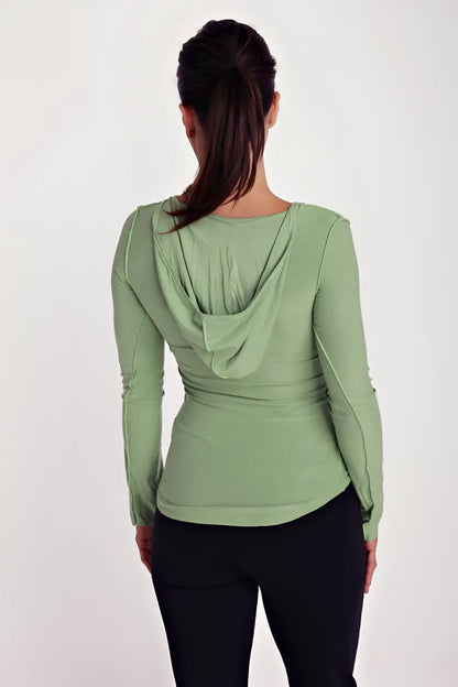 Soft sage green bamboo long sleeve top with deep scoop neck and draped hooded back shown from back side