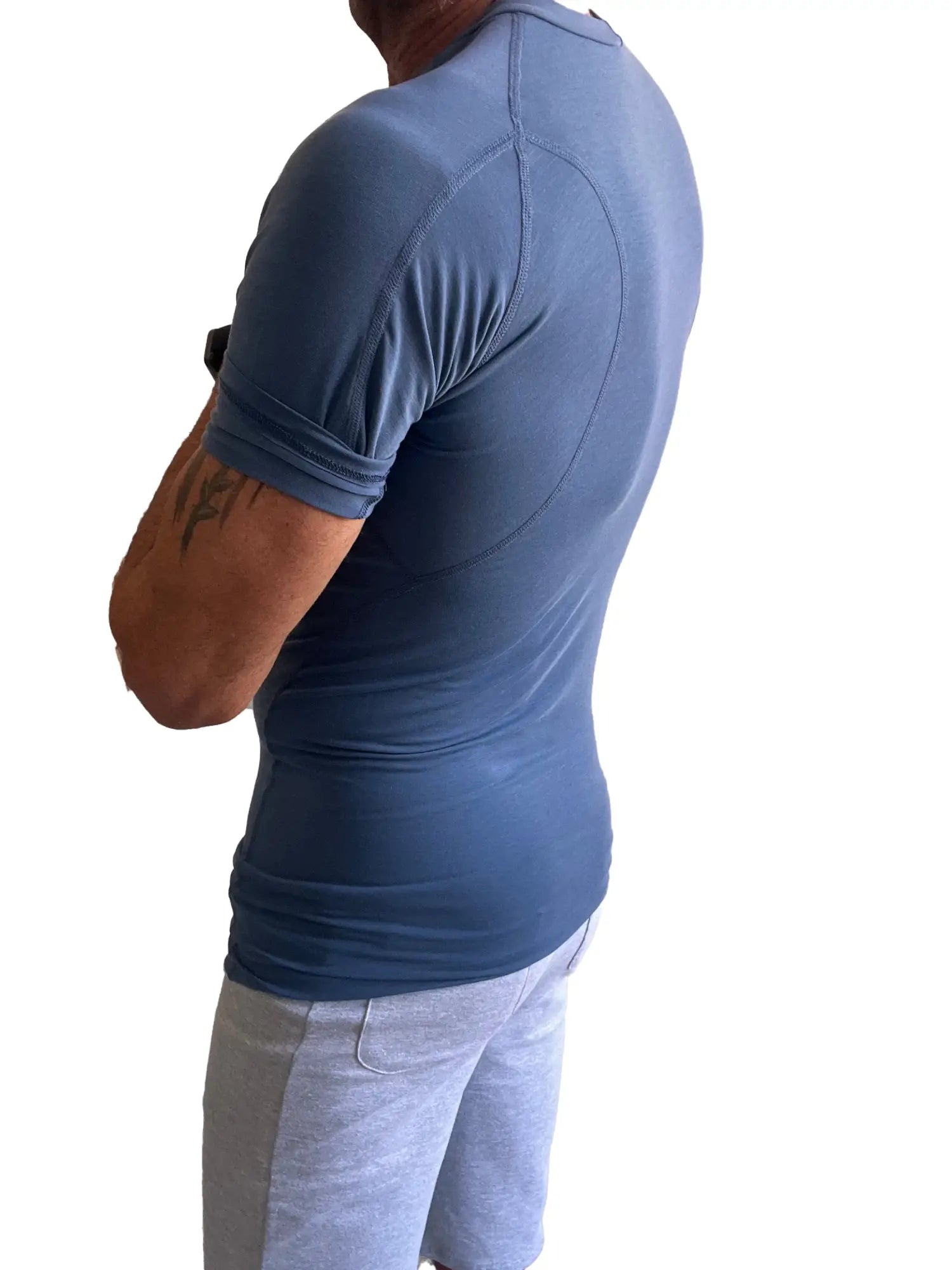Designer raglan crew-neck tee in denim blue is a fitted short-sleeved athletic shirt with subtle seam detailing and elasticated cuffs