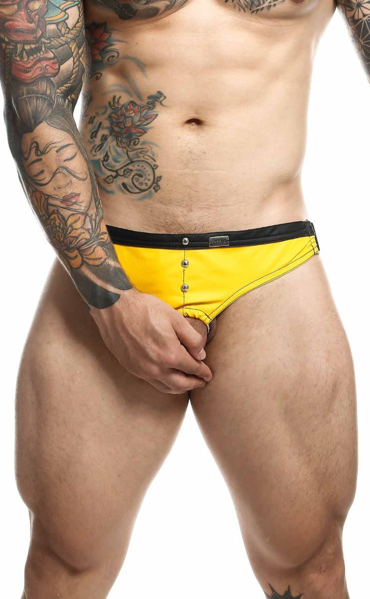 Bright yellow swim trunks with black waistband and silver button closures for dngeon c-ring jockstrap use