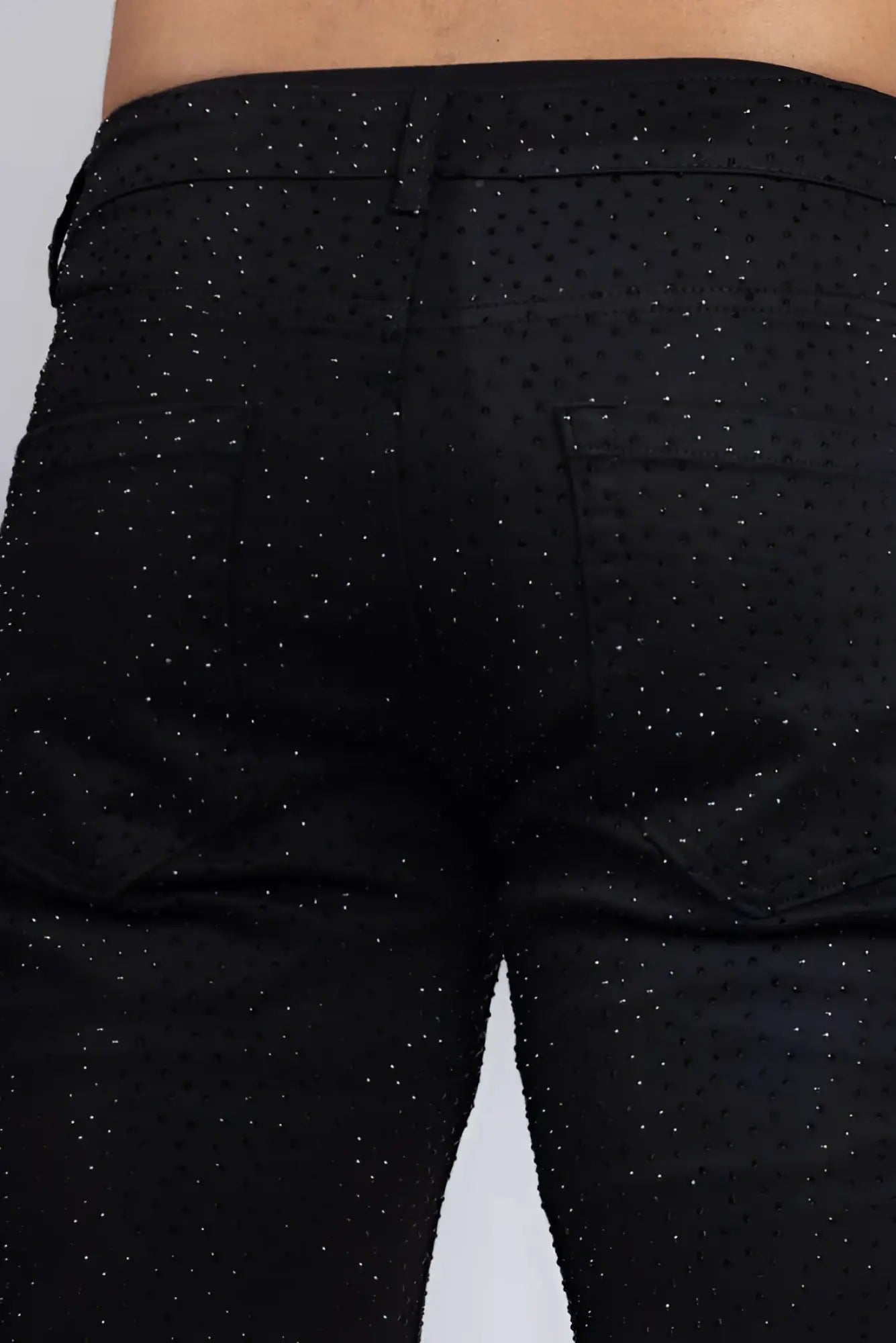 Black denim dolorosa rhinestone jeans with subtle glittery dot pattern across the fabric