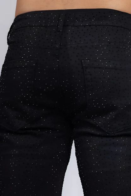 Black denim dolorosa rhinestone jeans with subtle glittery dot pattern across the fabric
