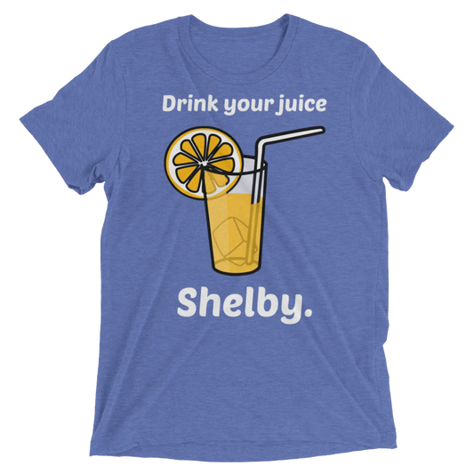 Blue heathered t-shirt featuring a cartoon glass of orange juice with lemon slice and text drink your juice shelby