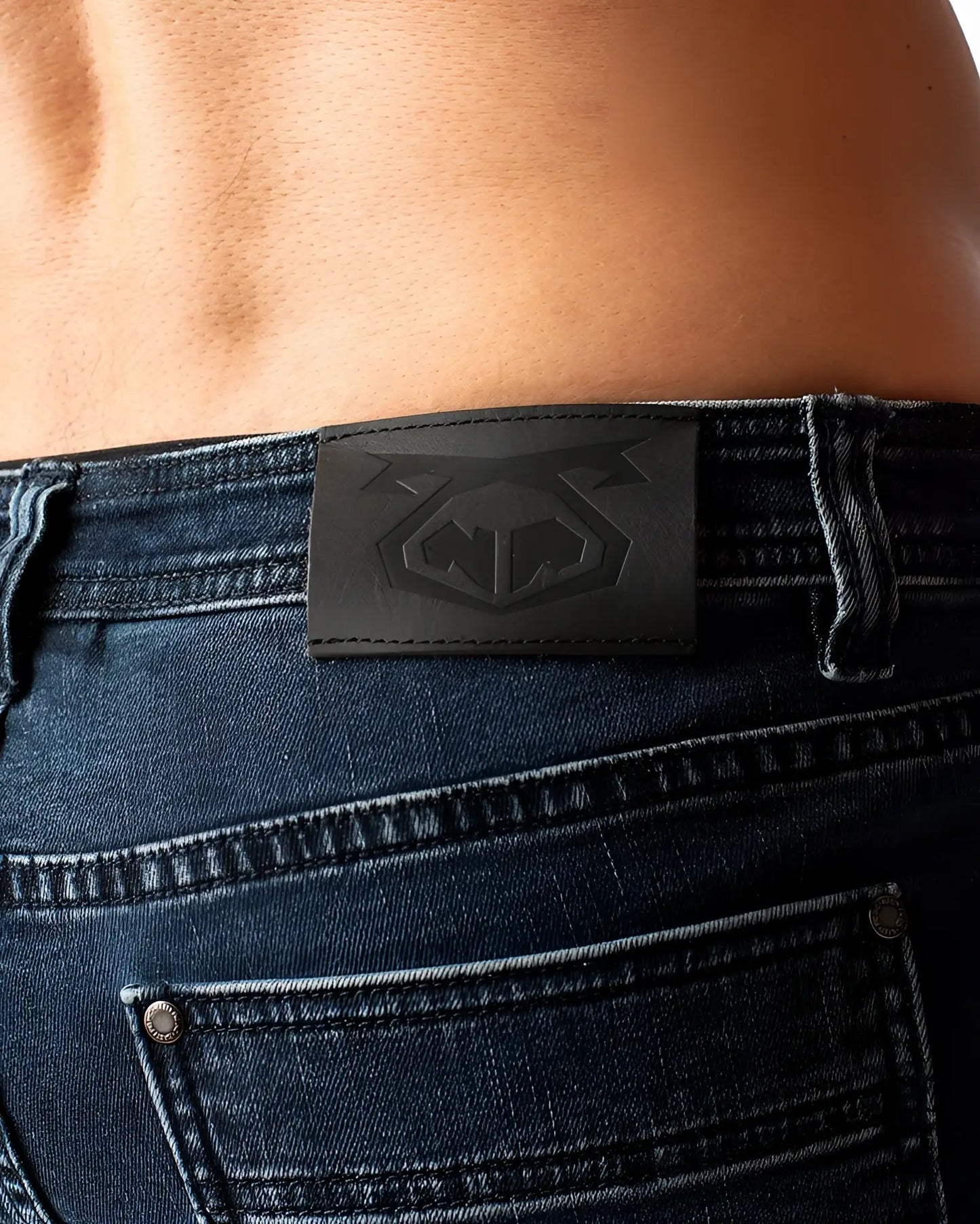 Black leather patch with embossed logo on the back of duke short dark blue denim jeans