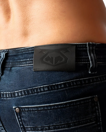 Black leather patch with embossed logo on the back of duke short dark blue denim jeans