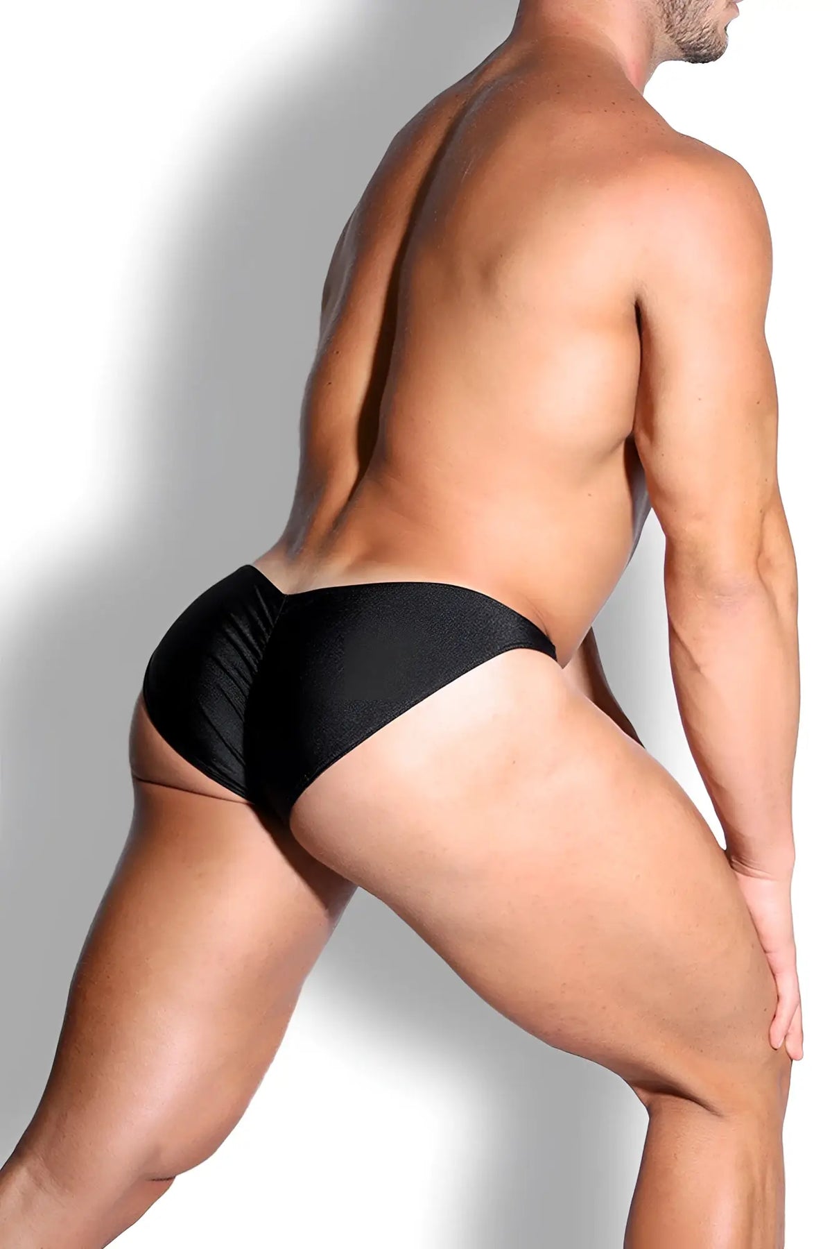 Dynamic classic scrunch-butt brief in jet black features form-fitting swim trunks with a subtle textured pattern