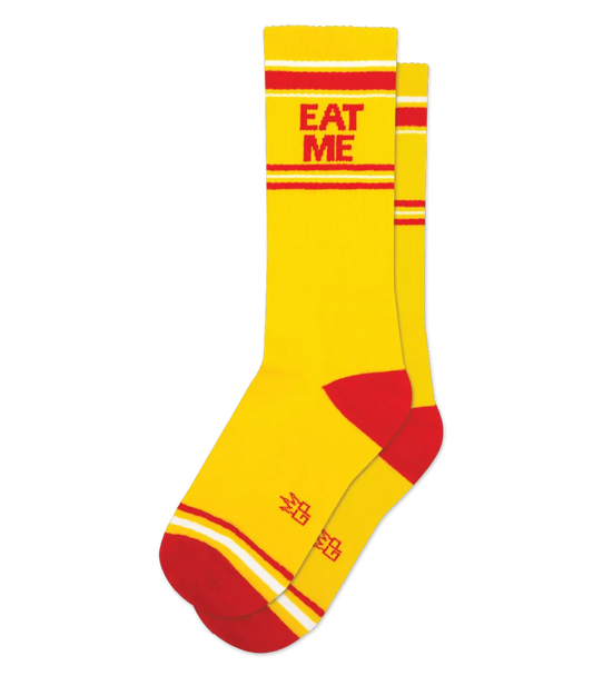 Eat me crew socks bright yellow with bold red stripes red toe heel and eat me printed on the cuff