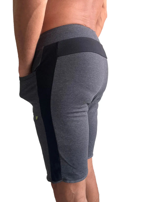 Eco-track short charcoal with black athletic shorts featuring ribbed waistband side panels and green logo on thigh