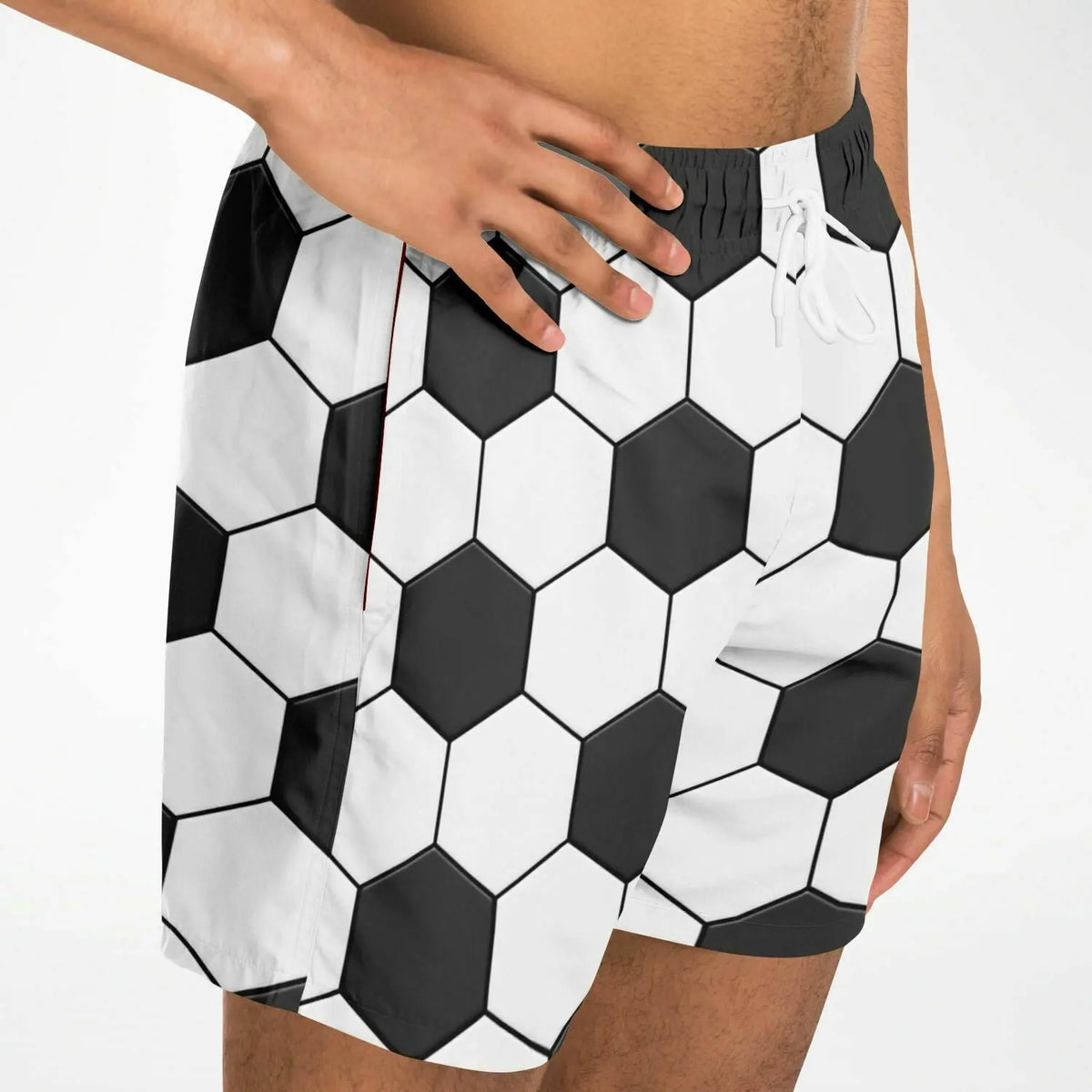 Men's swim shorts by Maris Equi featuring a black and white hexagonal soccer ball pattern with an elastic waistband and drawstring.