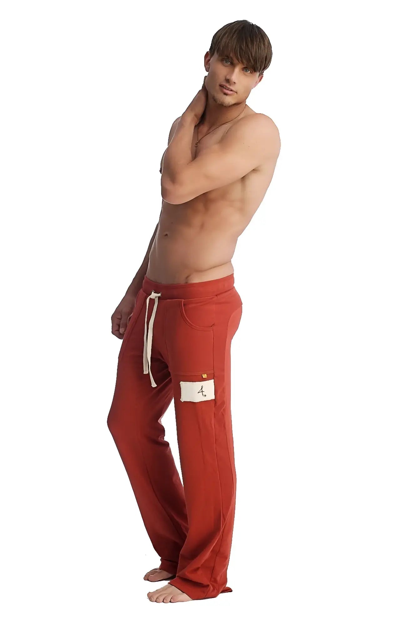 Red cotton edge eco-track and yoga sweat pant in cinnabar with white drawstrings and a patch on the left thigh
