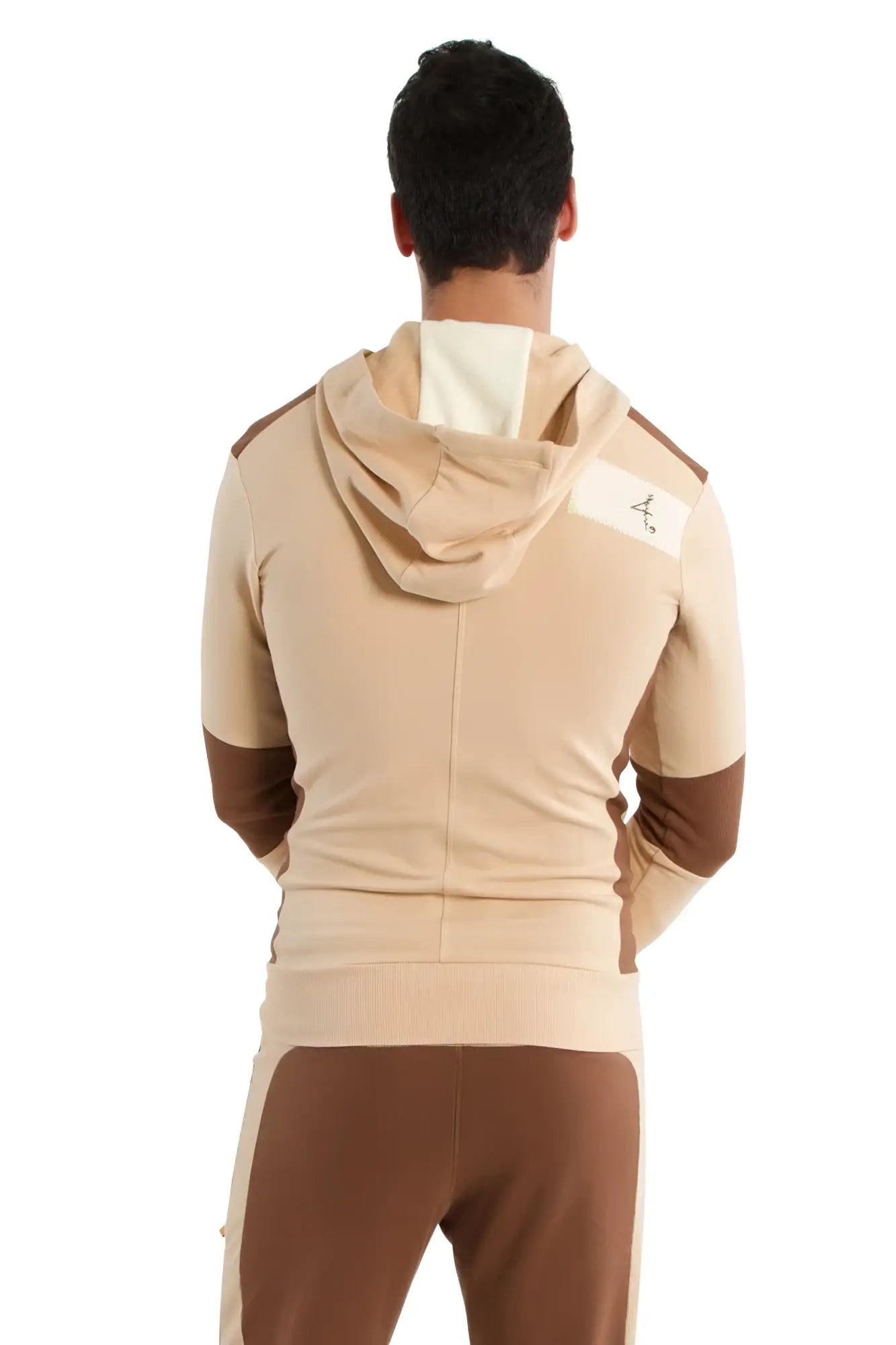 Edge form-fit crossover yoga track performance hoodie in sand and chocolate with white logo patch on the shoulder