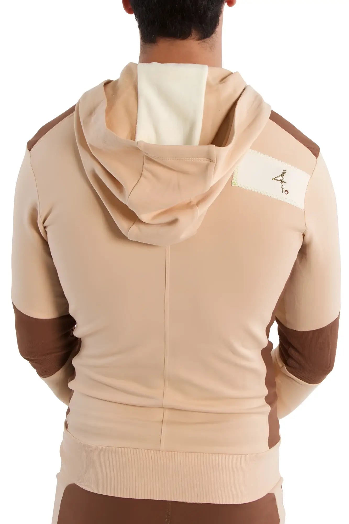 Edge form-fit crossover yoga track performance hoodie in sand and chocolate with white shoulder patch and black logo