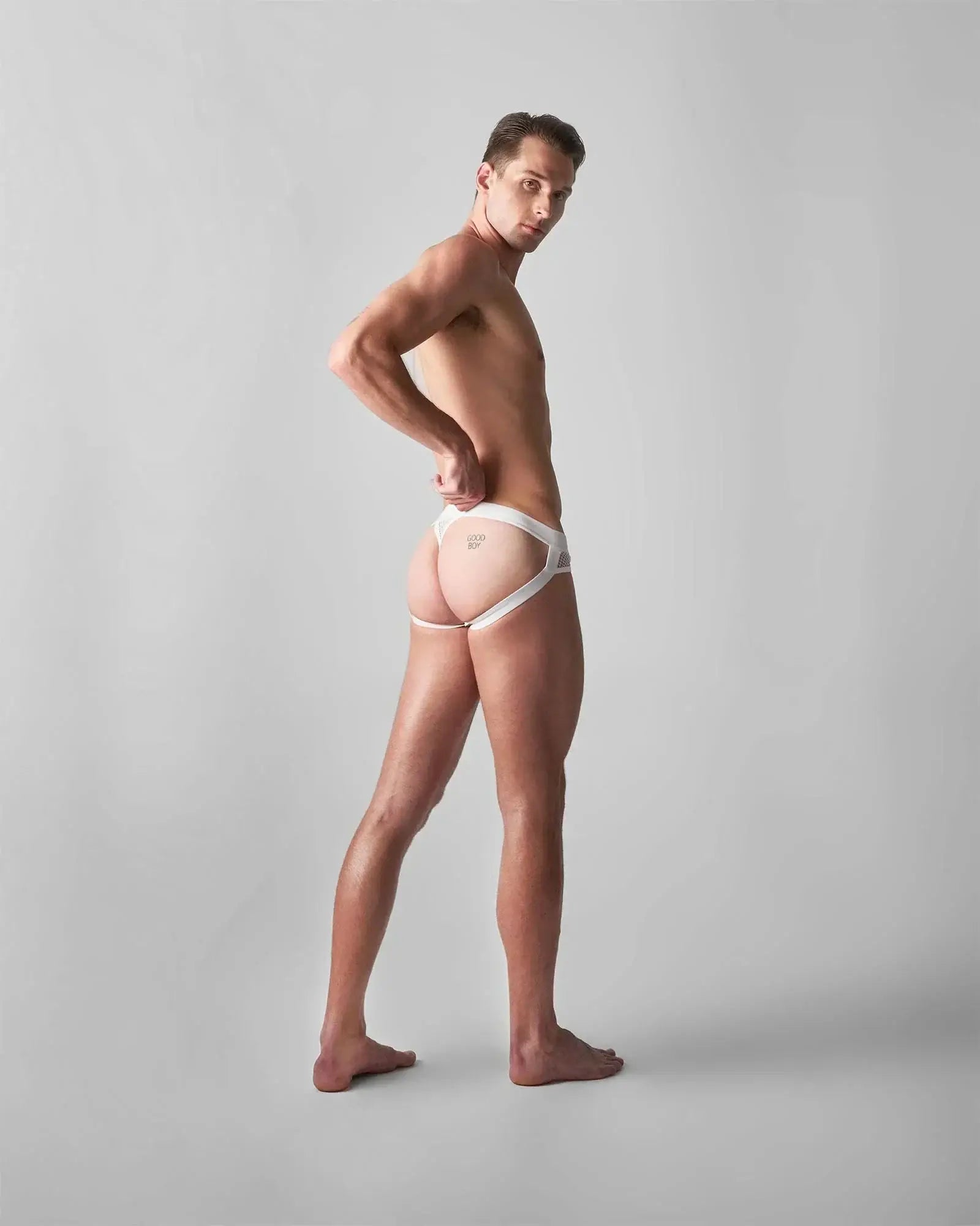 White lace-trimmed edge net jock thong with minimalist design and subtle branding on the front