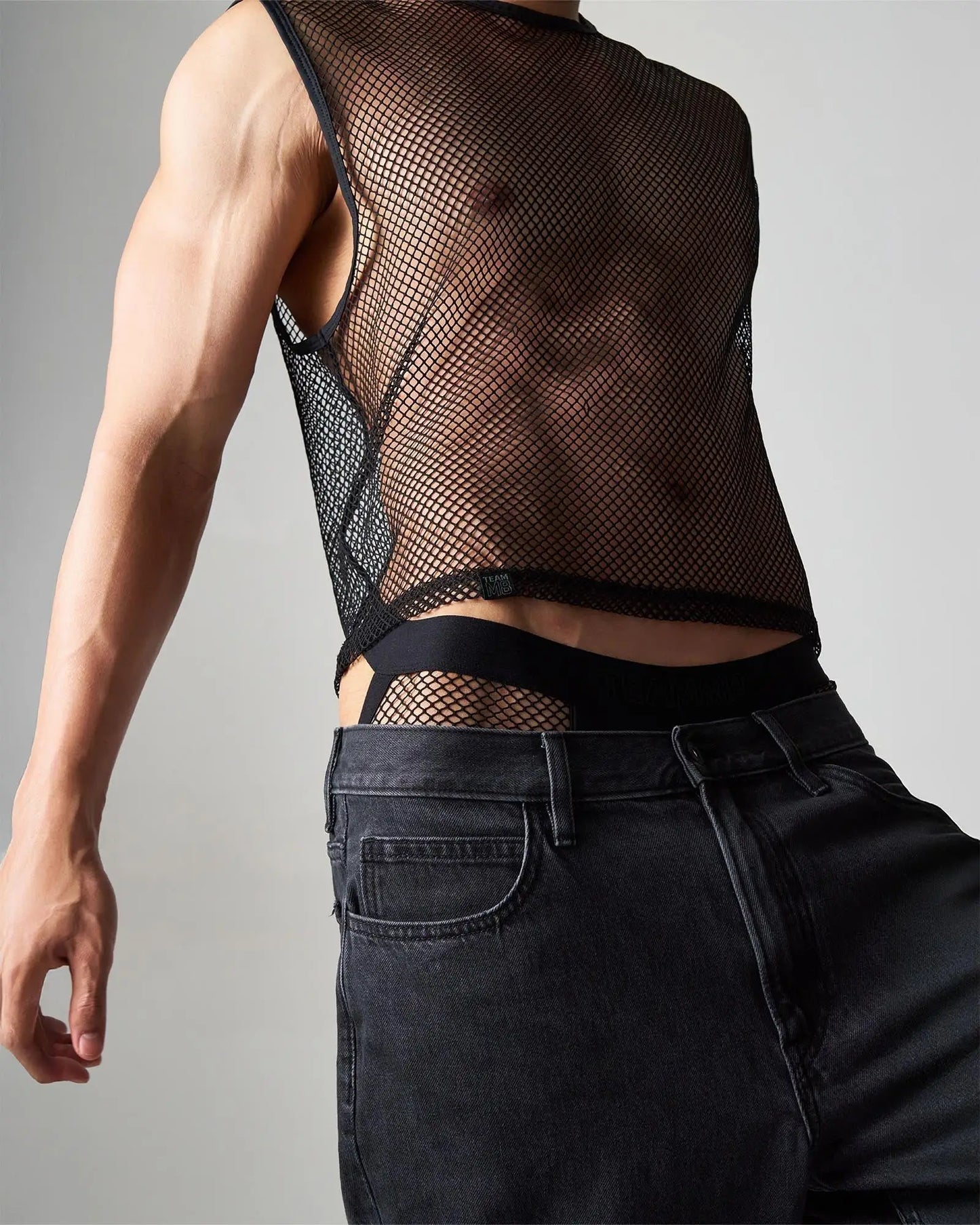 Black mesh sleeveless edge net mesh muscle tank with fitted cropped design made of breathable mesh material