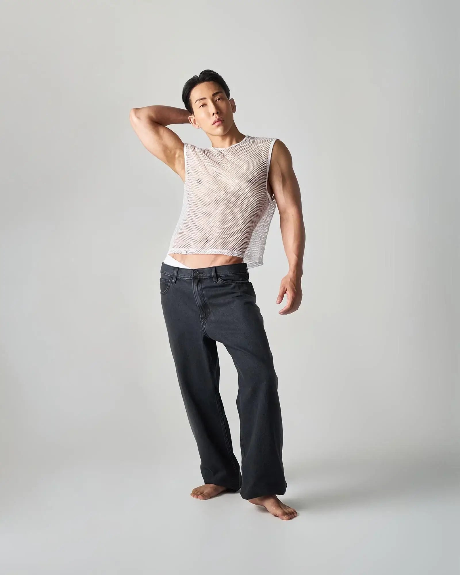 A white edge net mesh muscle tank with a fitted, semi-transparent sleeveless design