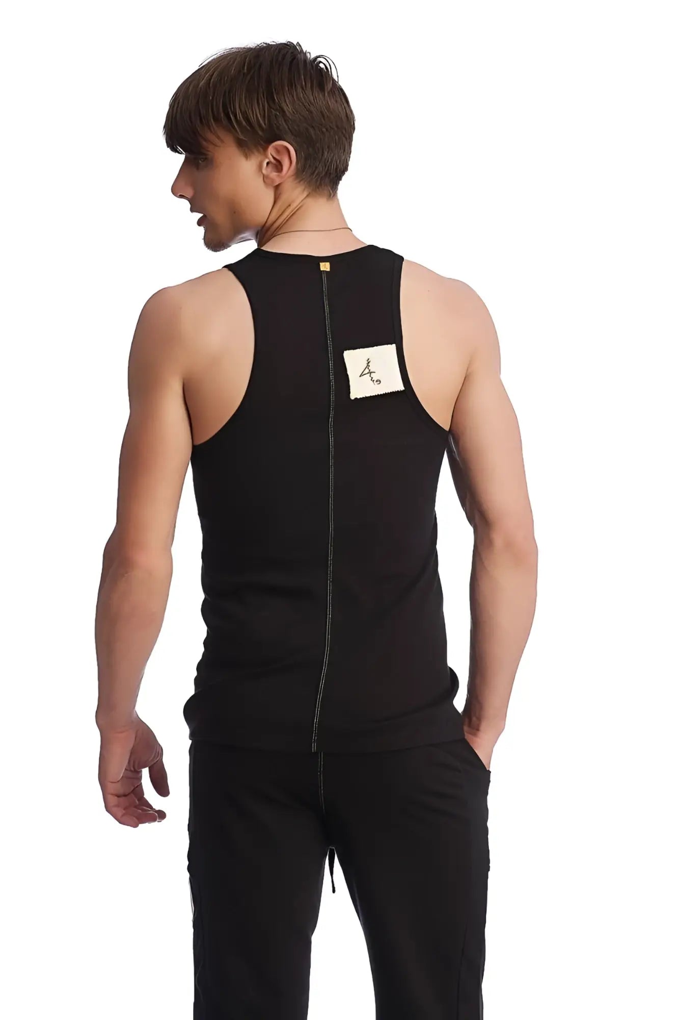 Back view of black edge sustain tank top with sleeveless design, central zipper, and white logo label