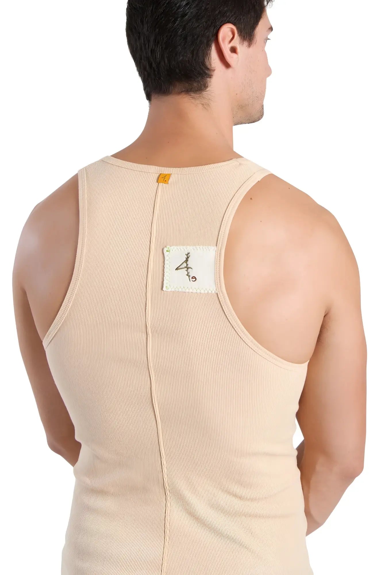 Back view of edge sustain tank top in sand beige ribbed cotton with central zipper and white label with black calligraphy