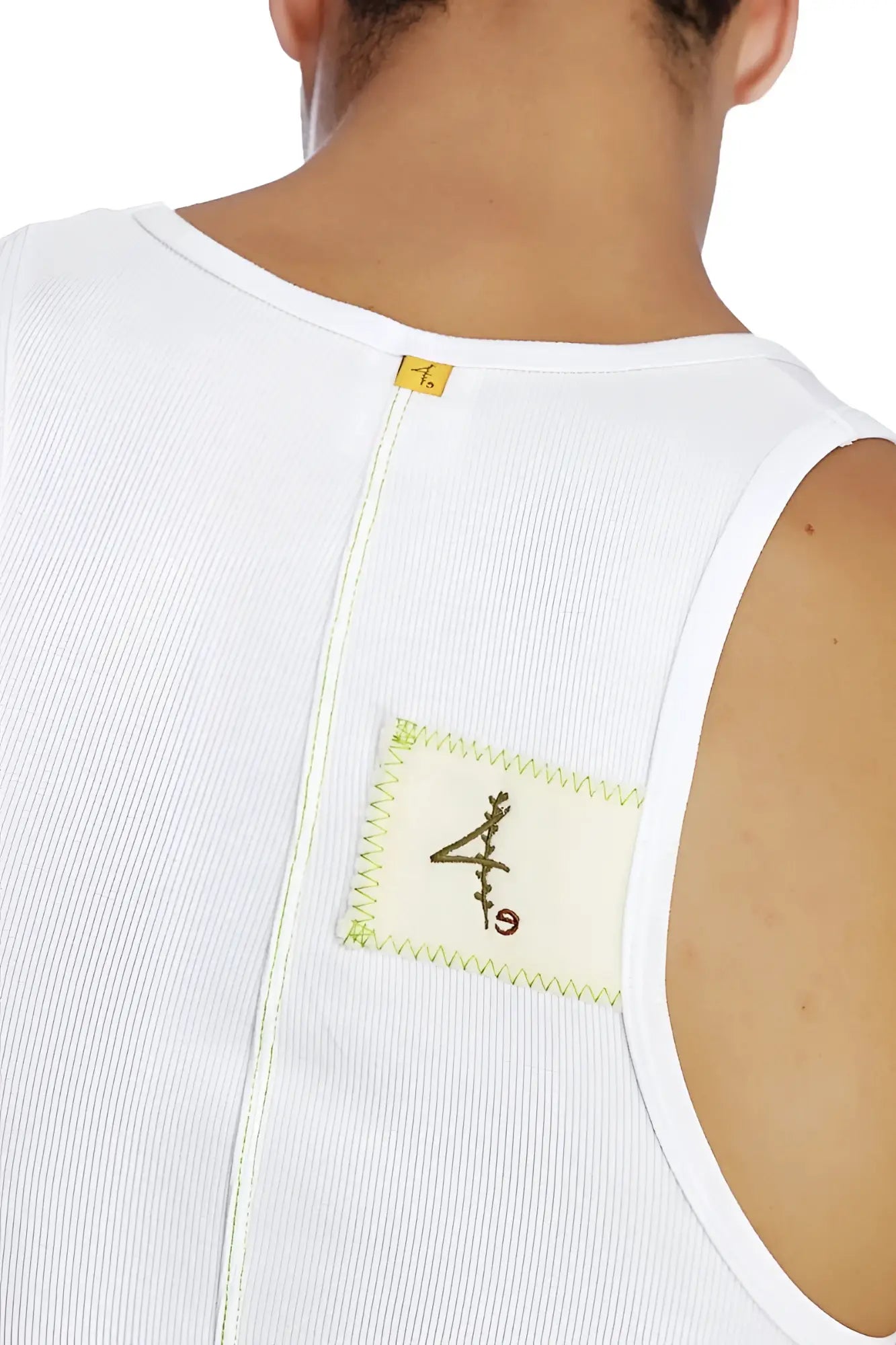 White ribbed sleeveless edge sustain tank top with cream patch, black embroidery, and lime green zigzag stitching