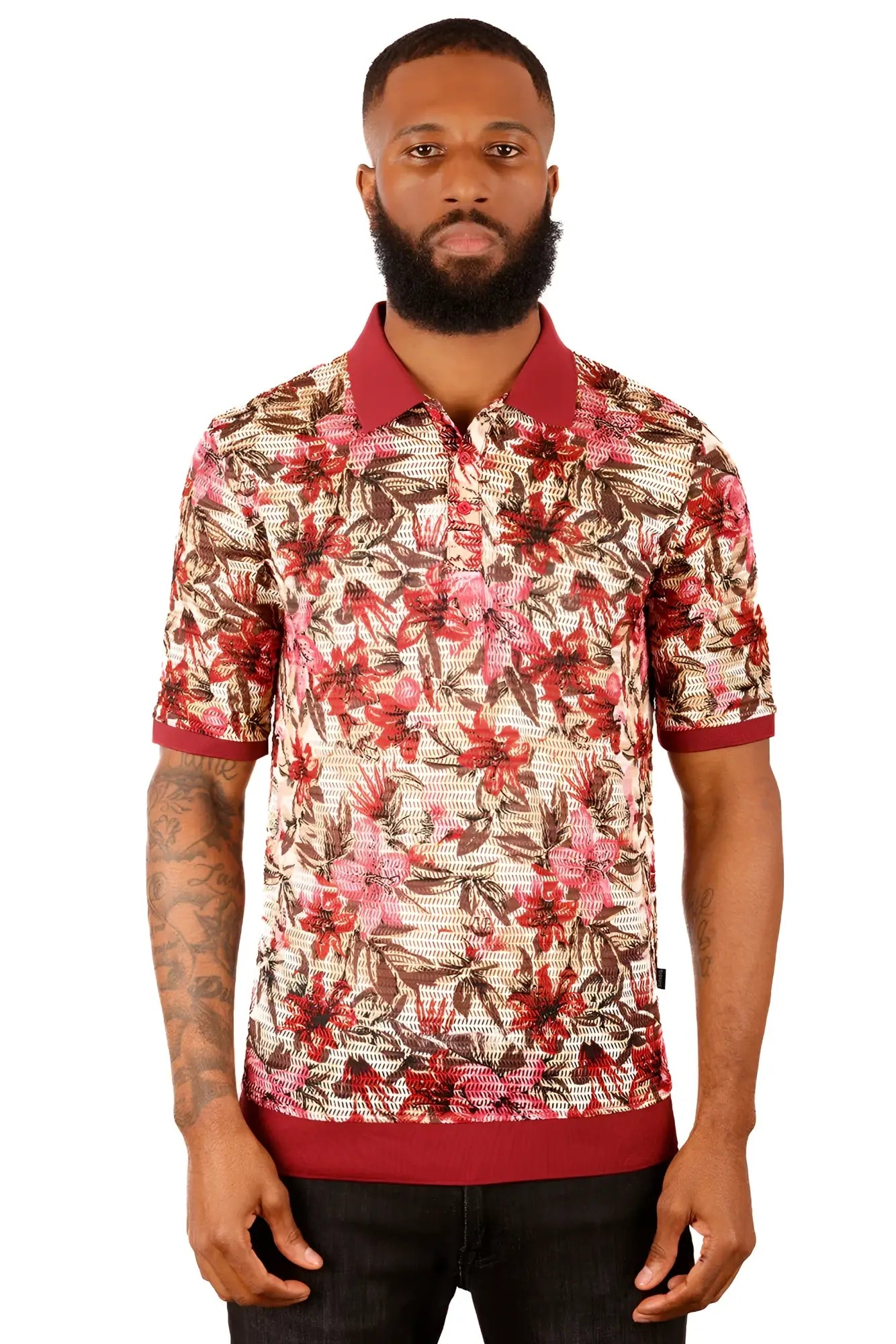 A man wearing an entwine form polo shirt with red and brown floral pattern on light beige with maroon trim