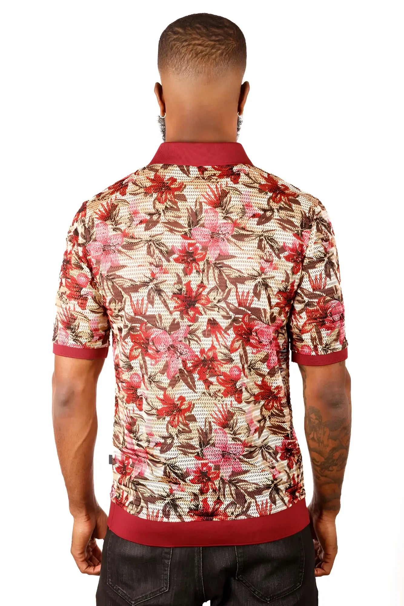A man wearing an entwine form polo shirt with red pink and brown floral pattern on beige mesh with maroon accents