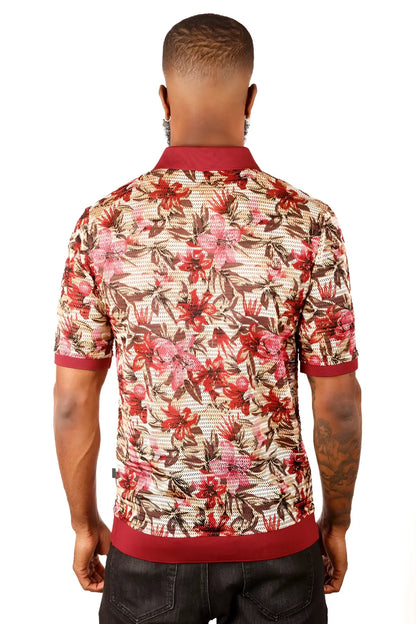 A man wearing an entwine form polo shirt with red pink and brown floral pattern on beige mesh with maroon accents