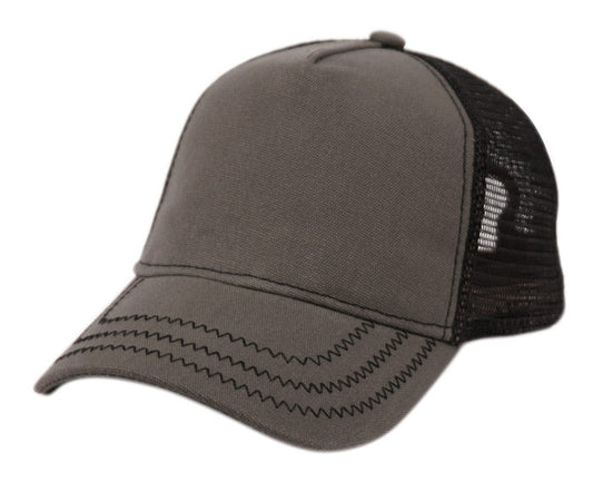 Grey trucker cap with black mesh back and zigzag stitching on the brim.