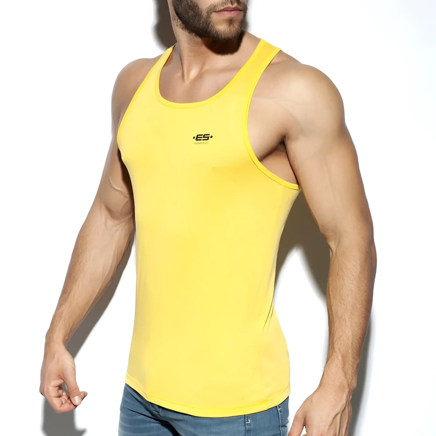 Bright yellow form-fitting ES Basic Tank with a small black logo on the chest made from soft breathable fabric