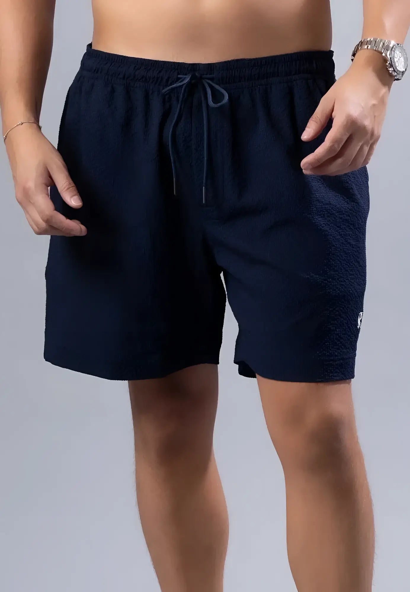 Navy blue textured essential swim short with matching drawstring waistband available in three colors