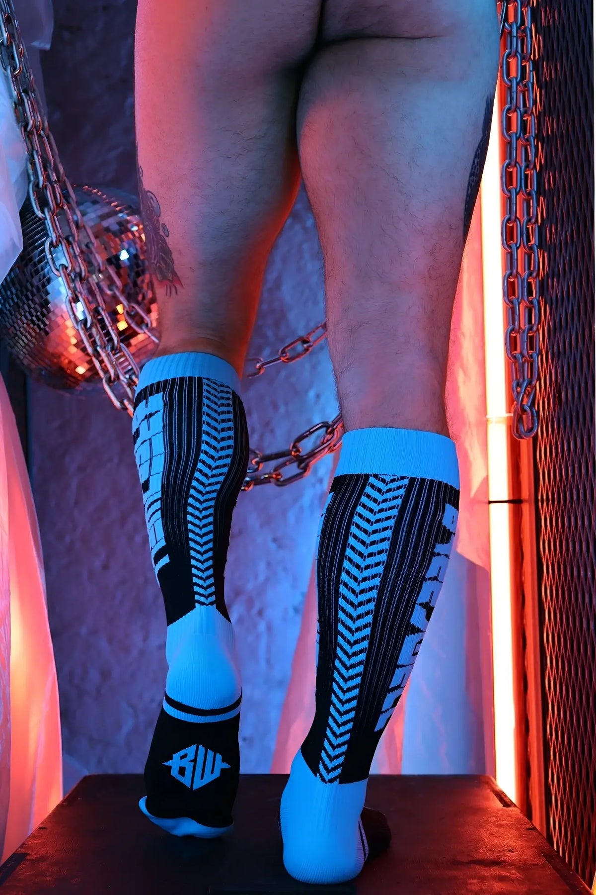 Eternity socks in black and bright blue with a bold chevron pattern and bil logo on the heel back side view