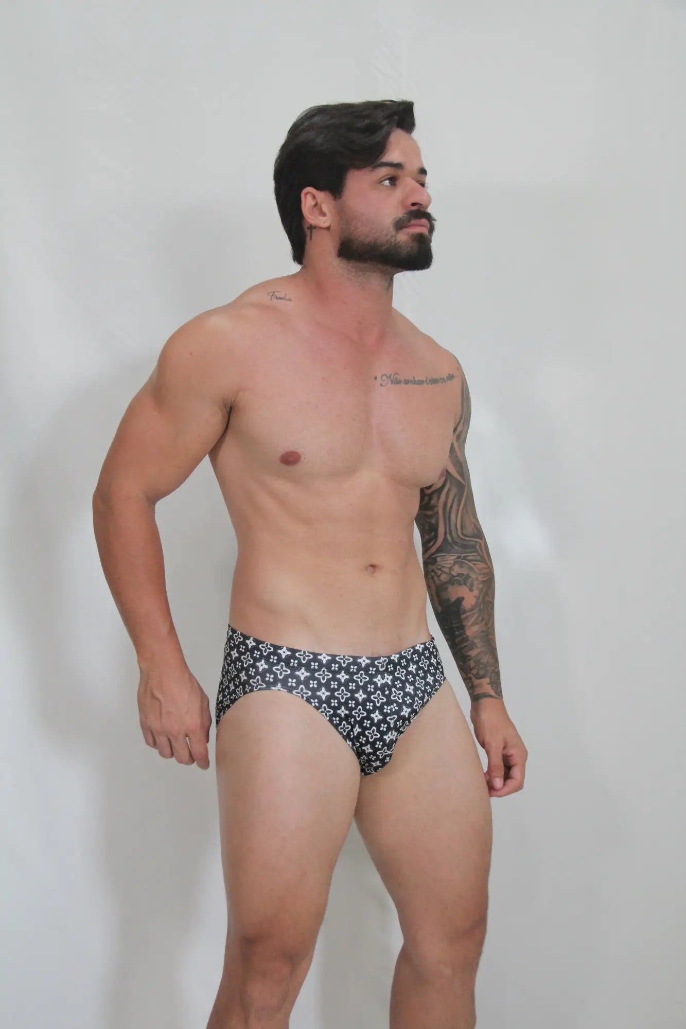 Black and white patterned fancy symbols swim brief with repeating geometric design for stylish swimwear use