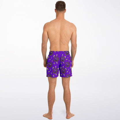Men's purple swim shorts with Day of the Dead pattern featuring colorful skulls by Maris Equi shown on a model from the back.