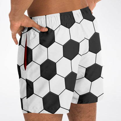 Men's swim shorts by Maris Equi featuring a black and white hexagonal soccer ball pattern with side pockets and an elastic waistband.