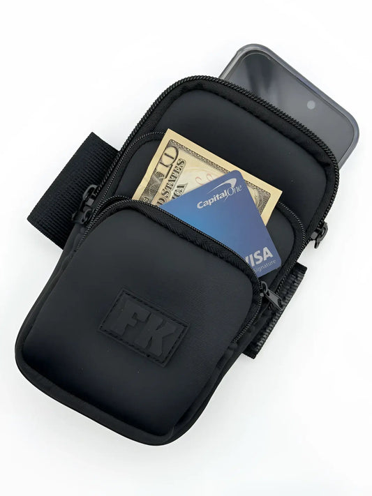Black fk sport 3 pocket neoprene arm pouch with zippered compartments holding cash and a phone