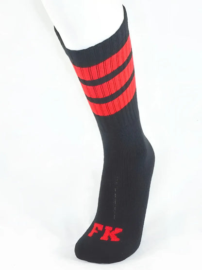 Black athletic tube sock with bold red stripes and matching fk logo on the toe for sport use
