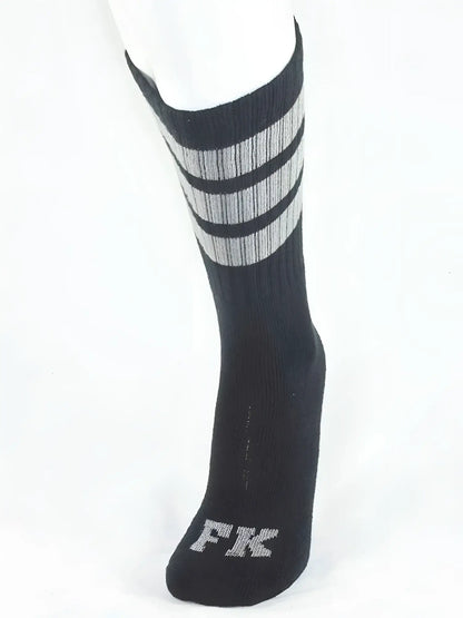 Fk sport black tube sock with three gray stripes and silver fk logo embroidered on the toe for athletic use