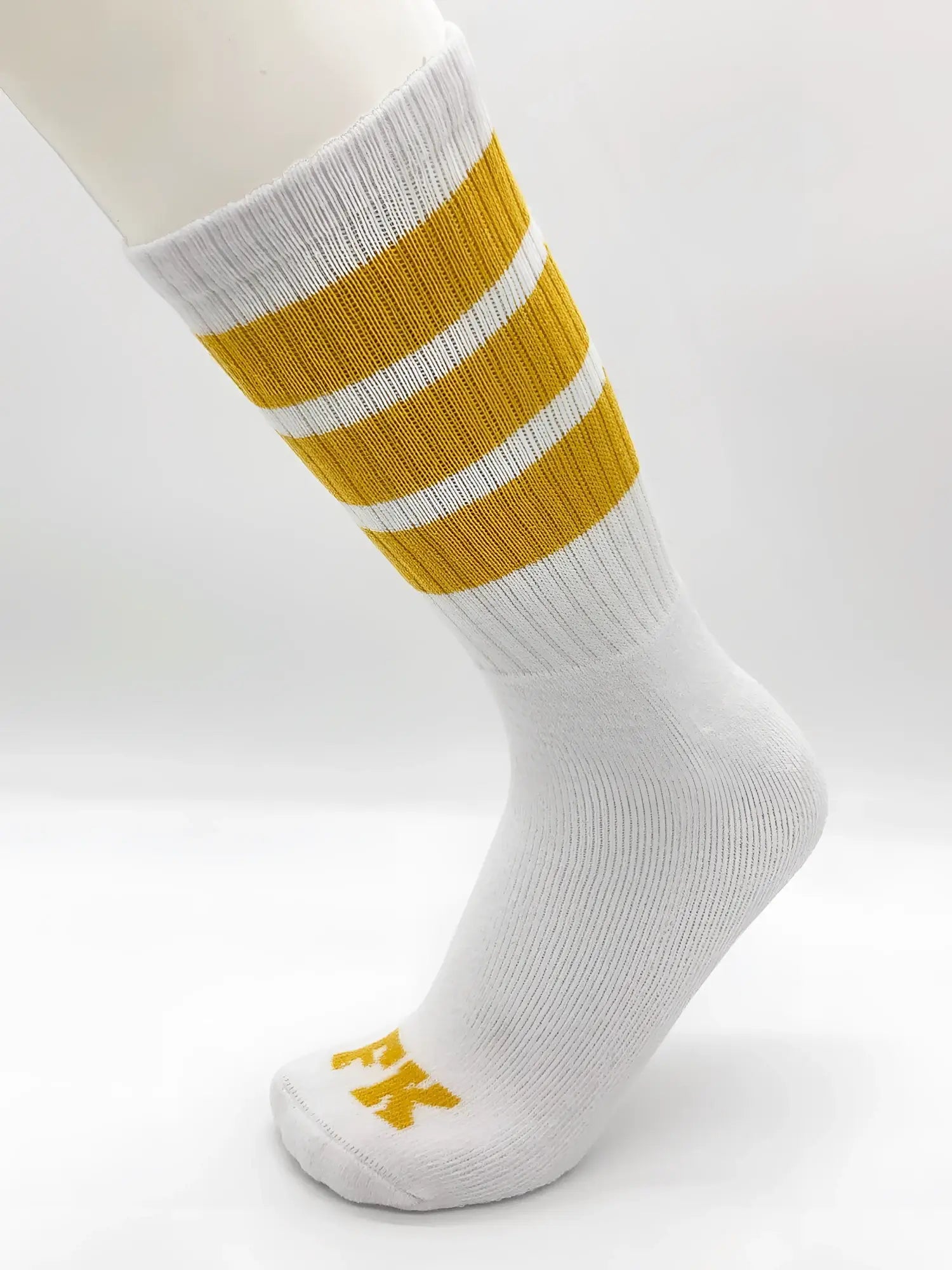 Fk sport white tube sock with three mustard-yellow stripes and small yellow logo on the toe in athletic style
