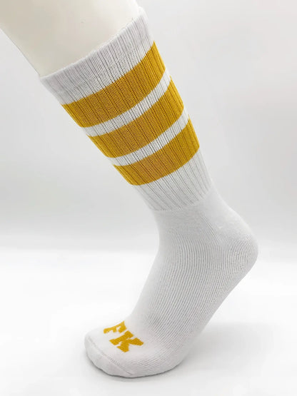 Fk sport white tube sock with three mustard-yellow stripes and small yellow logo on the toe in athletic style