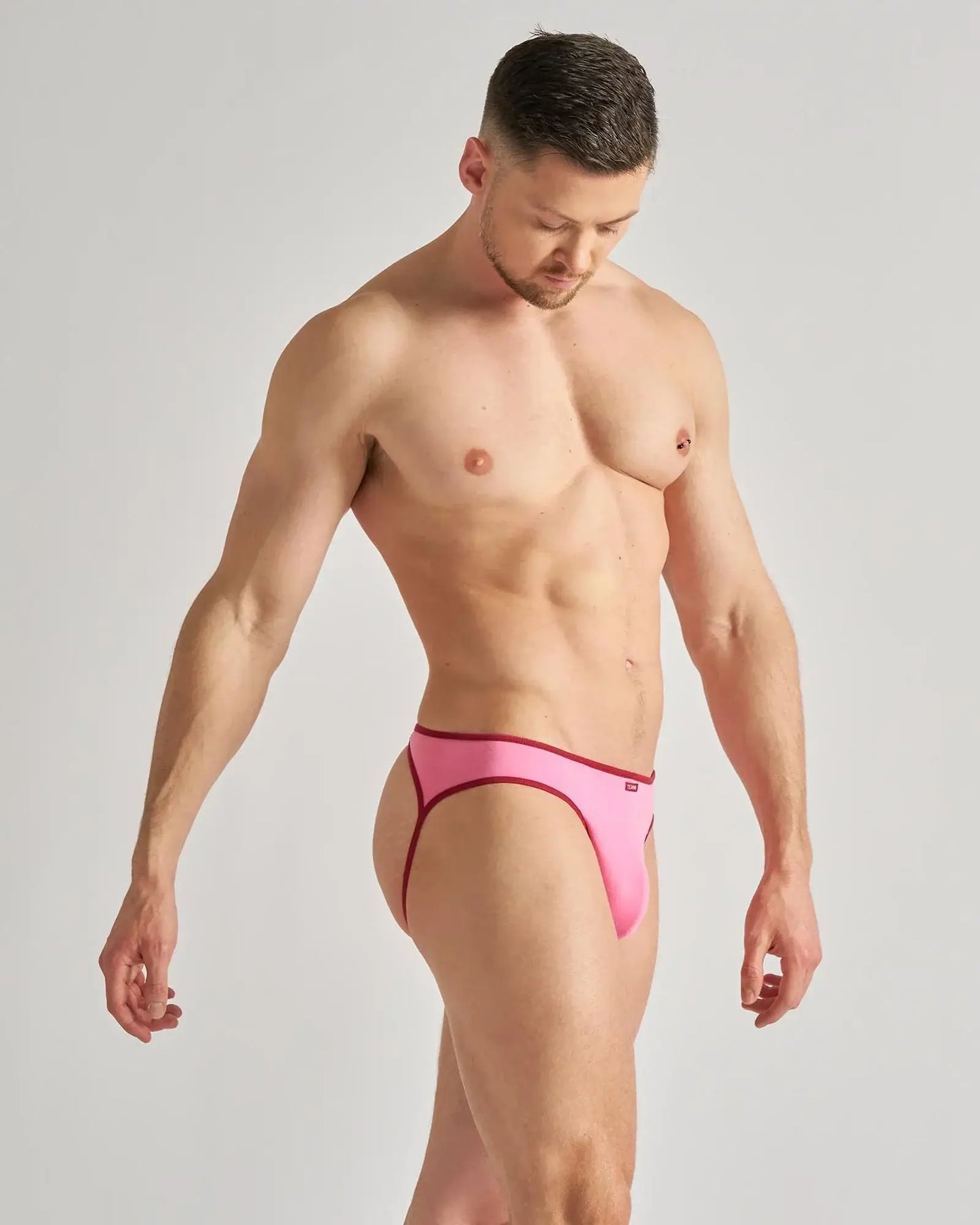 Bright pink flaunt jockstrap briefs with form-fitting design and contrasting dark red trim for bold style