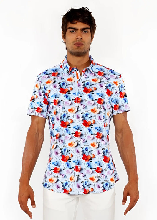A white floral 3d print stretch knit shirt with bold red and blue blossoms and delicate pink accents