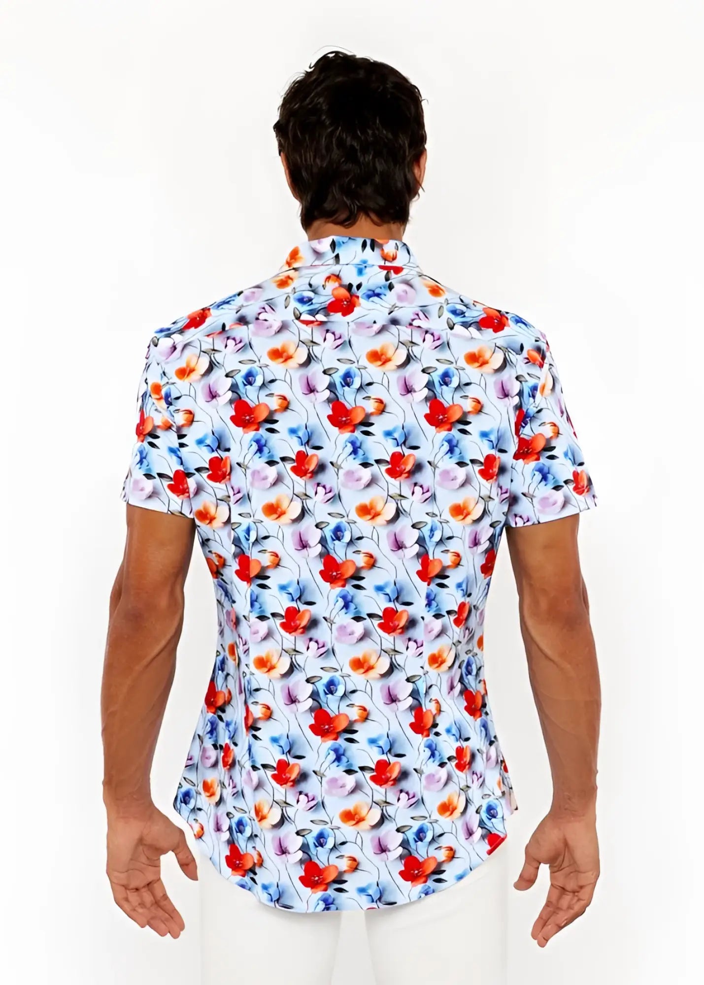 A vibrant floral 3d print stretch knit short-sleeved men’s shirt with red orange blue and purple blossoms on light blue